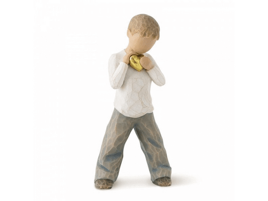 This beautiful Willow Tree sculpture shows a young boy with a smooth, featureless face, standing with both hands clasped close to his chest, cupping a shiny, golden heart. The figurine has a soft, matte finish, painted in earthy colours in gentle hues. This heartfelt figurine makes a perfect gift for any occasion, expressing emotions of love and affection without the need for words.