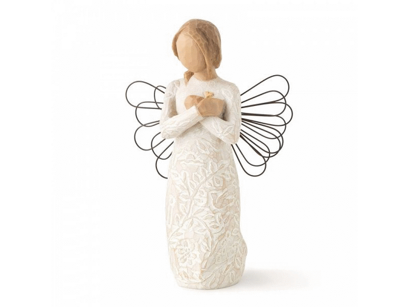 A Willow Tree cast stone figurine of a feminine angel with overlapped hands resting on her chest, wearing a dress embossed with flowers, leaves, and a small 3D heart. Adorned with wire wings resembling sparkler art and painted in soft, earthy tones of cream, beige, and brown.
