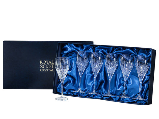 Six large wine glasses with the London cut pattern on the outside of the bowls, which has a bed of diamonds at the base and single flicks that go up towards the smooth rim. They come in a navy-blue silk-lined presentation box with gold branding on the lid.