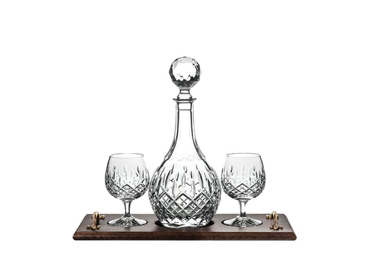 A set of crystal brandy glasses and a matching tumbler, sat on a solid oak tray with gold handles