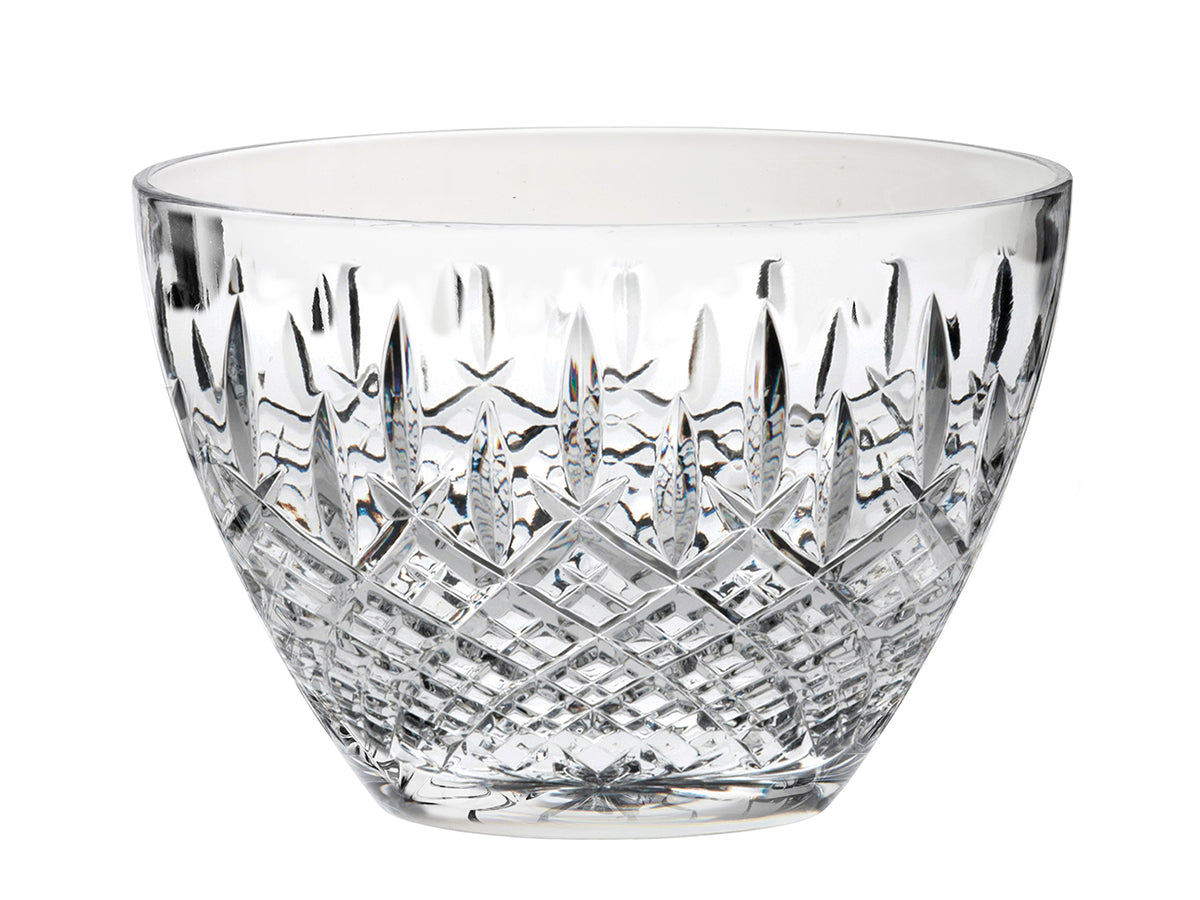 A deep crystal bowl with a cut pattern around the outside