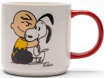 Experience heartwarming vibes with this Magpie & Peanuts mug featuring a cosy illustration of Charlie Brown hugging Snoopy. The handle's red hue perfectly matches the warm sentiment of the mug, while the back reads "Happiness is a Warm Puppy" in playful black text.