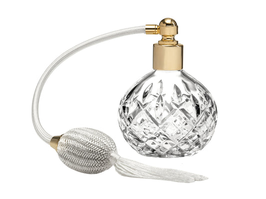 A round crystal perfume atomiser with cut crystal detailing and a cream puffer
