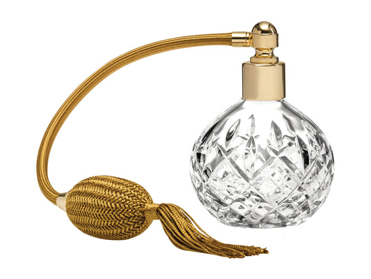 A classic crystal perfume atomiser with hand carved detailing, topped with gold hardware and puffer