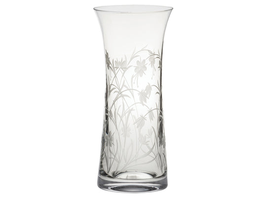 A tall crystal vase with a wildflower motif engraved into the outside, giving a frosted effect. It flares gently at the lip