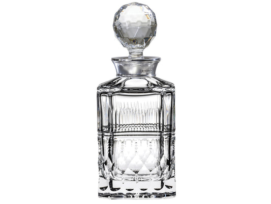 A crystal decanter with a silver collar and round stopper, cut with a prism effect detail around the outside.