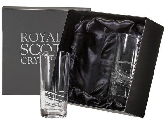 A pair of cut glass crystal highball glasses with sweeping orbital designs around the base. They come in a slate-grey silk-lined presentation boxes with silver branding on the lid.