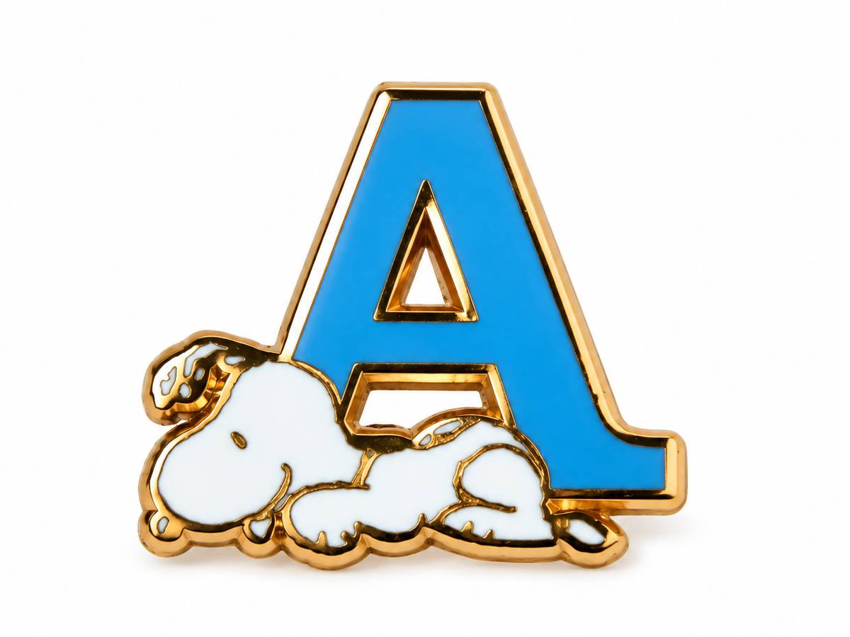 A gold-tone enamel pin featuring a large blue letter 'A' with a white sleeping dog character at its base, shown on a plain white background.
