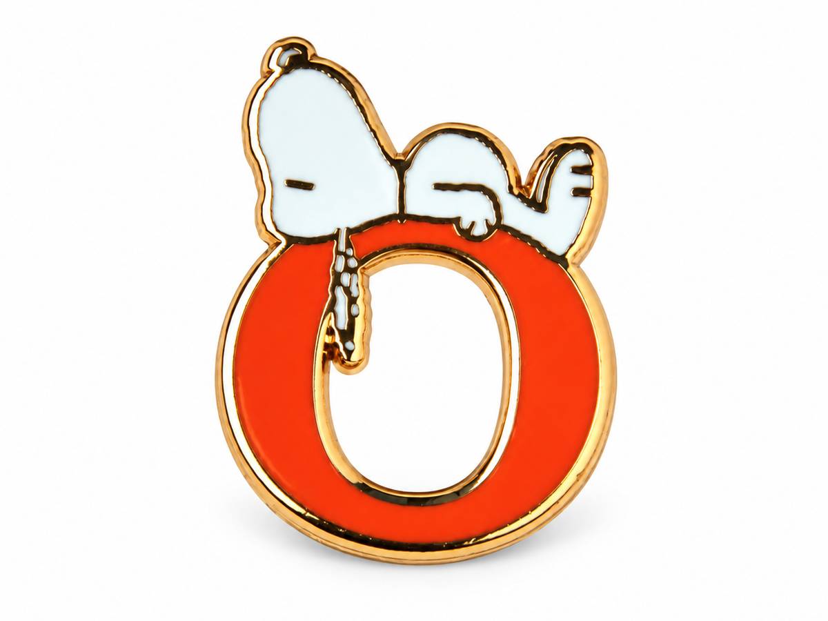A Snoopy enamel pin shaped like the letter O, featuring Snoopy lying on top in white with gold metal outlines and a bright red-orange enamel fill.