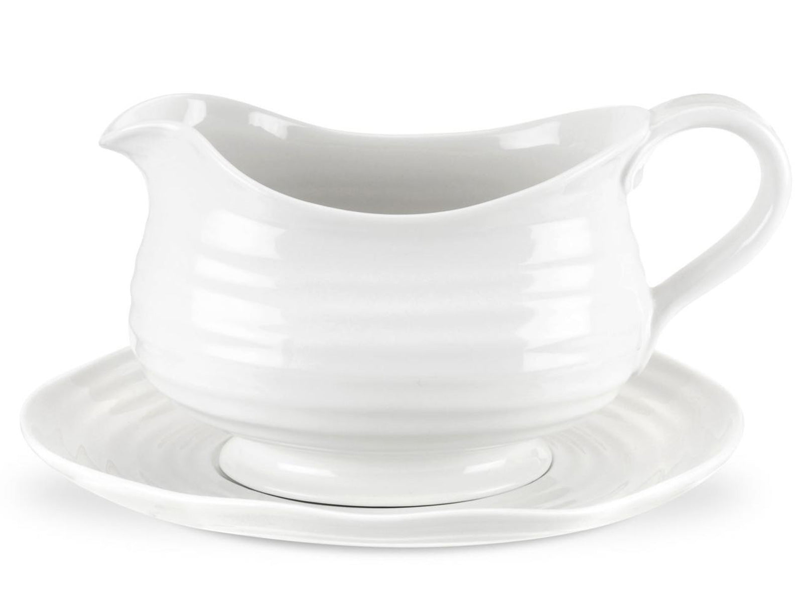 a rippled white porcelain gravy boat with a matching plate