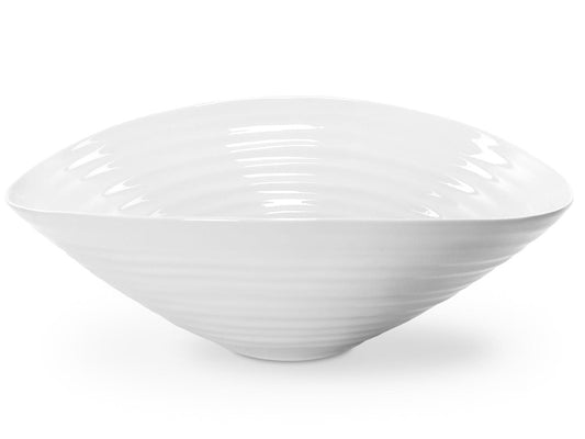 an asymmetrical white porcelain salad bowl with a rippled texture