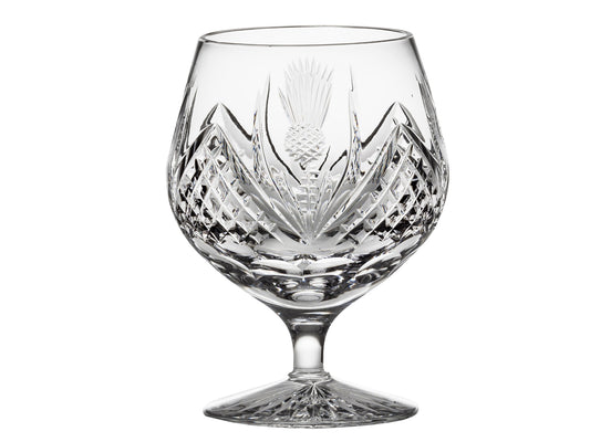 A short-stemmed crystal brandy glass with a rounded bowl, hand-cut with a bed of diamonds and scottish thistle motifs going around the outside.