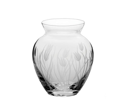 A small crystal vase with a high waist and flared neck that is clear with a frsoted tulip design cut into the exterior